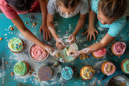 Parents and children baking cupcakes together, decorating them with colorful frosting and sprinkles. Children having fun making cupcakes, sharing food and water on table photo