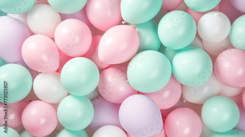 A bunch of balloons in different colors, including pink, green, and white