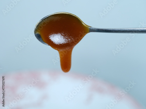 A close-up of some honey on a spoon. March 1, 2024 - Paris, France. 