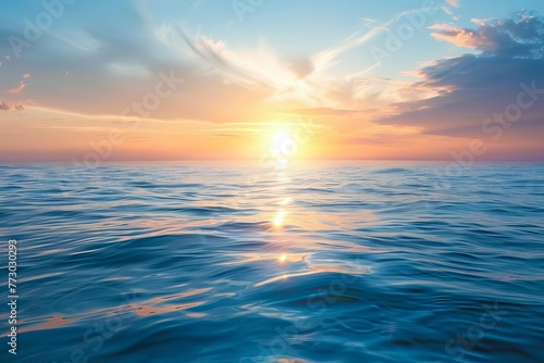 Serene ocean panorama at sunrise with sun reflecting on calm rippling waves, tranquil seascape photo
