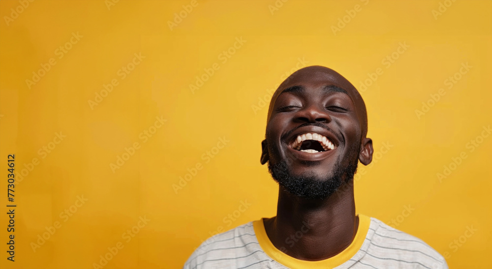 A man with a beard is smiling and laughing. The yellow background adds a warm and cheerful atmosphere to the image. Bald black guy smiling with mouth closed, eyes wide and excited of winning a prize A man with a beard is smiling and laughing. The yellow background adds a warm and cheerful atmosphere to the image. Bald black guy smiling with mouth closed, eyes wide and excited of winning a prize