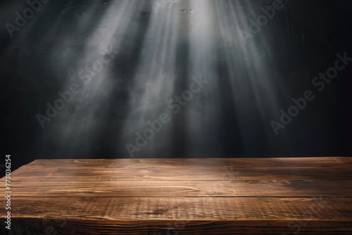 empty wooden table with soft light sun flare emit on dark background