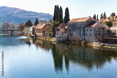Serene river scene in Trebinje, Bosnia with historic buildings and greenery. Travel and vacation concept