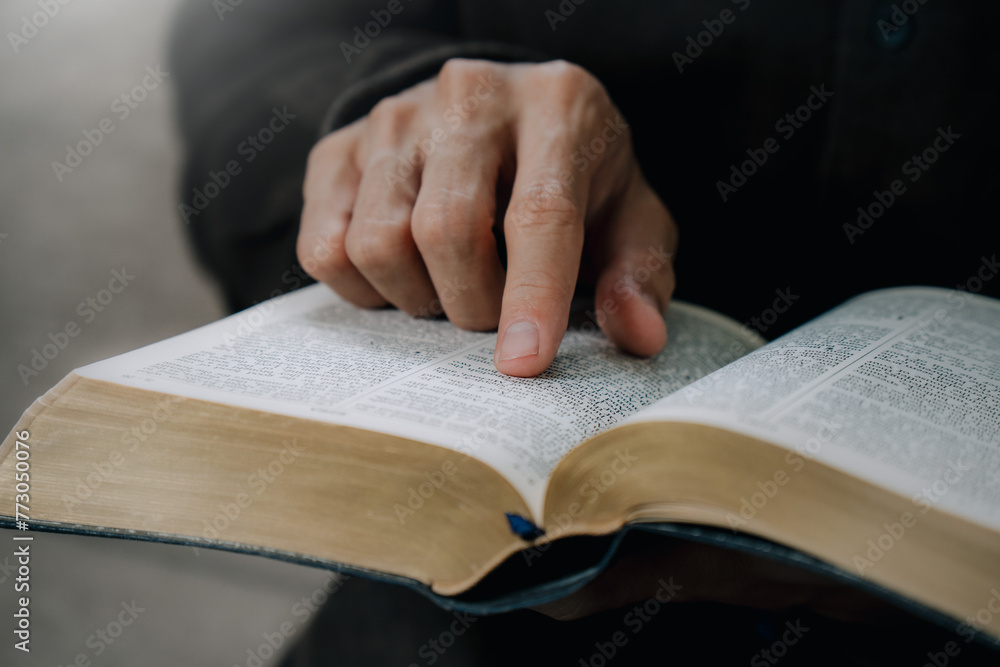 Christian man reading the Holy Bible to praying to God in the sunday morning.spirituality, religion,believe.Christian life.Studying the word of God in church. Christian man reading the Holy Bible to praying to God in the sunday morning.spirituality, religion,believe.Christian life.Studying the word of God in church.