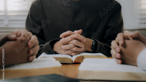 Group of christian people reading the Holy Bible to pray and worship God together in the sunday morning.spirituality, religion,believe.Christian life.Studying the word of God in church. photo