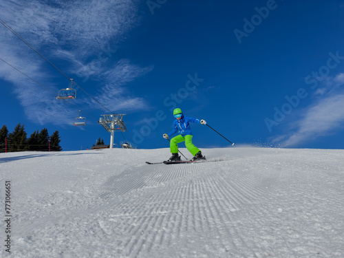Happy kid in dynamic ski slope moment at alpine mountain resort