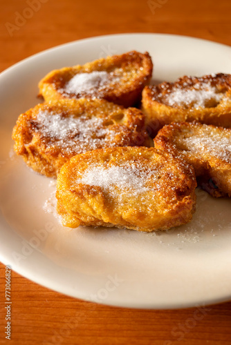 Detail of a plate of homemade "torrijas", a traditional spanish dessert during Lent and Easter, consisting of fried bread with milk, egg, cinnamon and sugar, sometimes also honey