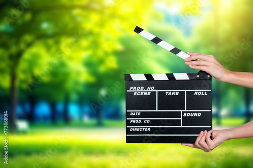 Director Holding classic Cinema Slate  at nature background