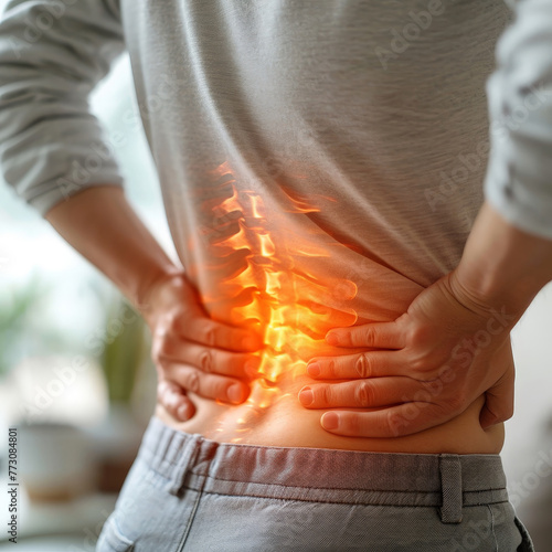 backside of person showing pain at the spine, concept image back pain or dorsal pain
