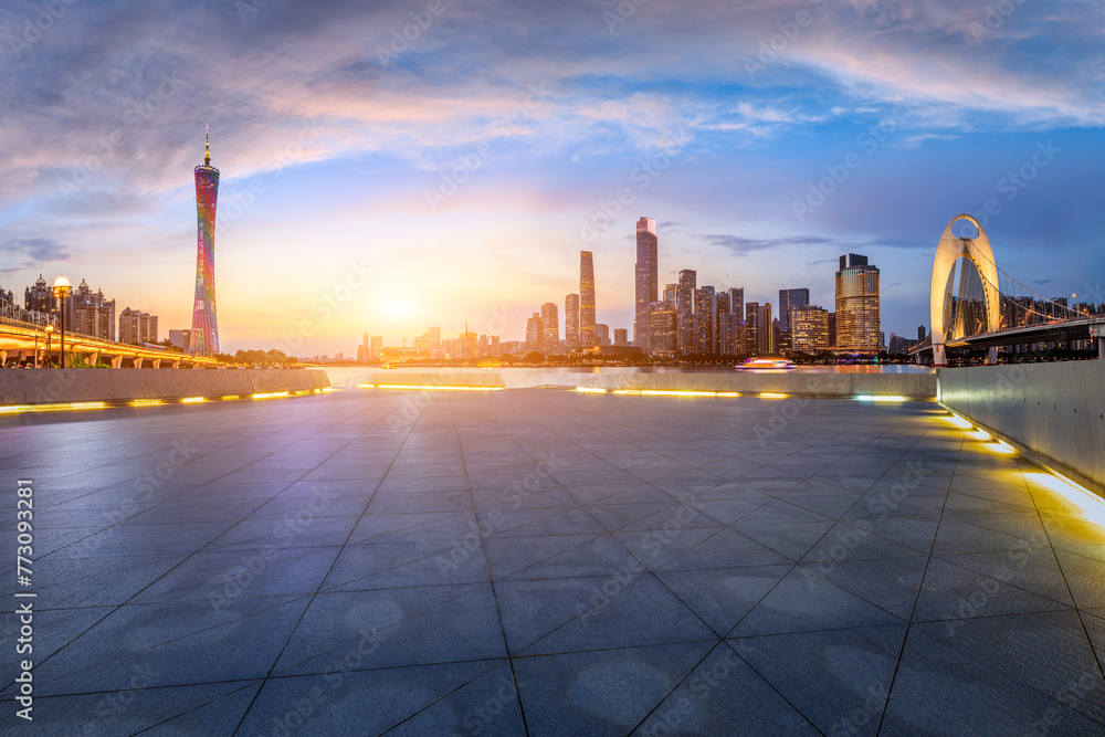 Empty square floors and city skyline with modern buildings at sunset in Guangzhou. Panoramic view.