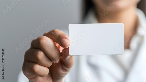 Close up of Patient s Hand Holding Medical Identification Card on Plain Background for Healthcare Services Advertising
