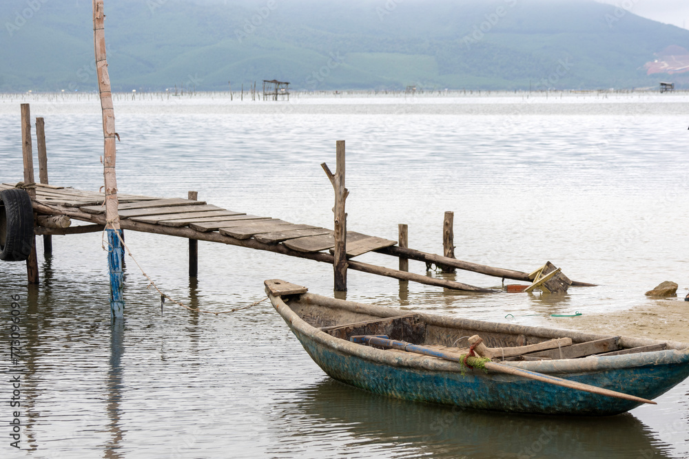 Traditional fishing boat in oyster farming industry in Lap An Lagoon, Vietnam