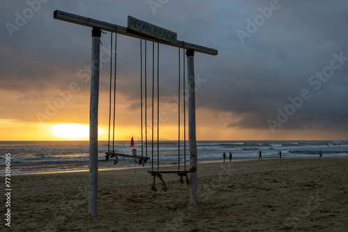 Sunrise on the My Khe beach in Vietnam with swing in silhouette