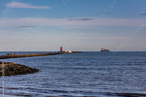 Poolbeg lighthouse in Dublin, Ireland in a beautiful sunny day with little clouds