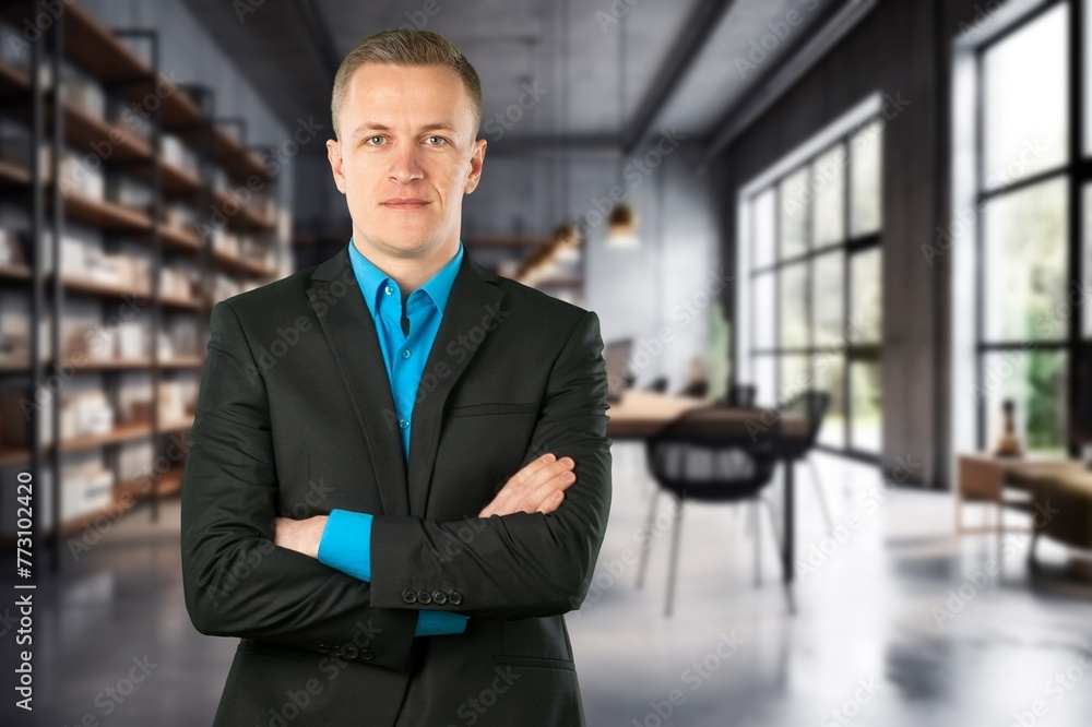 Portrait of successful businessman in suit working inside office building Portrait of successful businessman in suit working inside office building