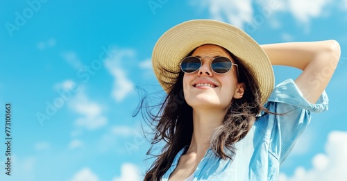 Joyful woman with sunglasses and hat relaxing in the sun.