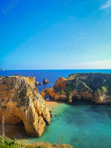 Coastal cliffs in Algarve, Portugal, illuminated by the bright afternoon sun