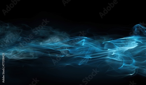 Blue smoke on a dark background. The concept of an abstract smoky backdrop.