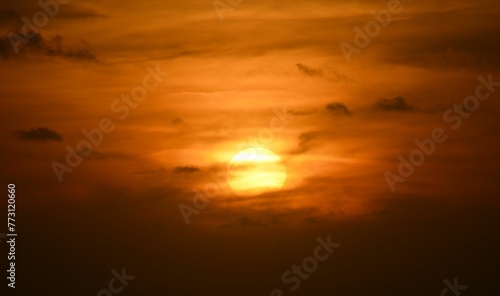 Stunning view of a beach shoreline with the sun setting in the horizon © Wirestock