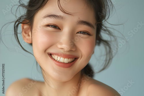 Closeup Beautiful smiling asian young woman with smooth healthy skin isolated on white background