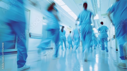 Long exposure blurred the motion of a busy hospital hall with medical professionals in scrubs walking. Emergency, Urgent Care, and Medical Professionals