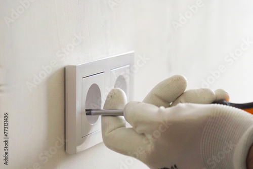 Installation of electric household socket on the wall during the renovation of the apartment © woff