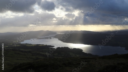 Scenic view of the tranquil ocean in Windermere, United Kingdom, with white fluffy clouds