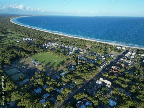 Aerial view of a town near the bright blue water on Bennett's Beach in Australia