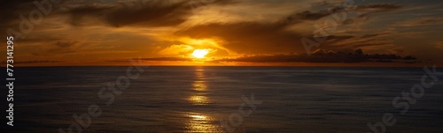 Stunning backdrop of a sun setting over the water © Wirestock