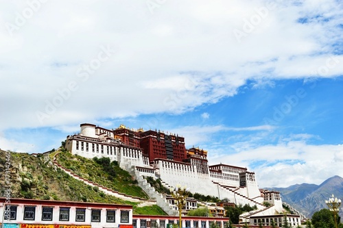Majestic Potala Palace on the peak of a hill on the background of the bright blue sky