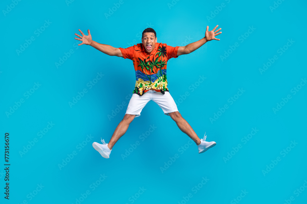 Full body photo of nice young man rejoice jump summer holiday isolated on blue color background