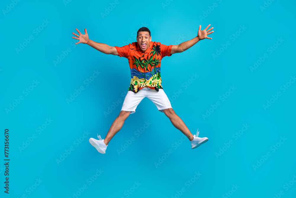Obraz premium Full body photo of nice young man rejoice jump summer holiday isolated on blue color background