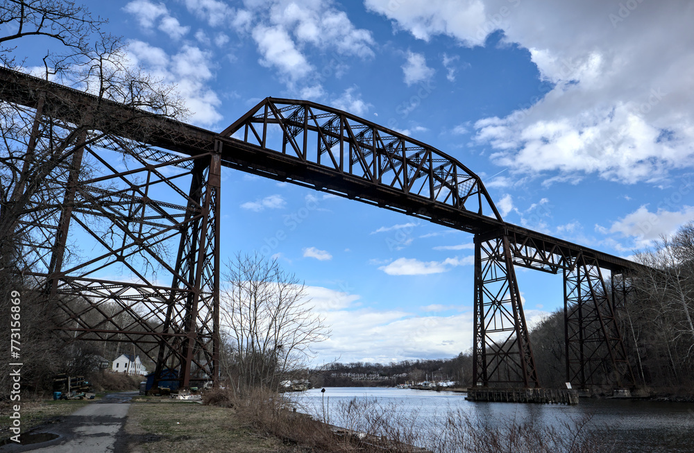 Fototapeta premium tall railway trestle bridge over the rondout creek in kingston new york (train tracks high up)