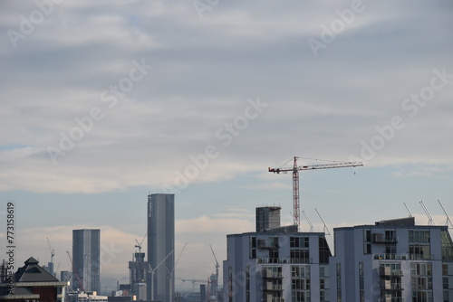 Aerial view of modern buildings with cranes on London