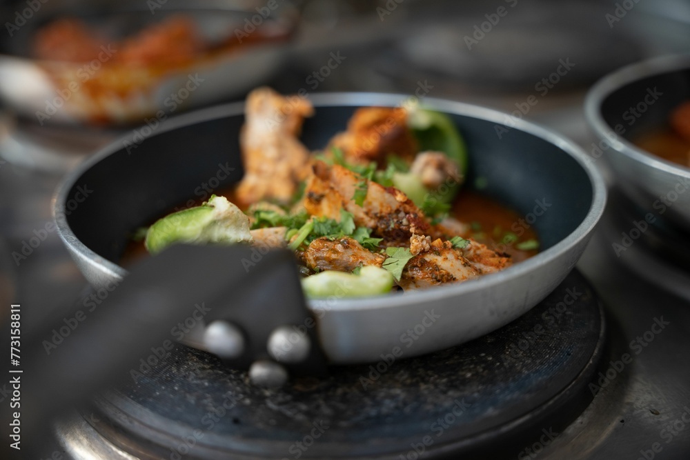 a bowl of soup sitting on top of an oven burner a bowl of soup sitting on top of an oven burner