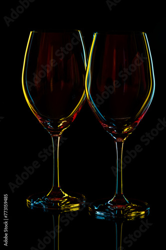 White Wine Glasses silhouette over Black Background.