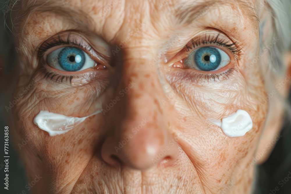 close-up of older woman's face with lotion close-up of older woman's face with lotion