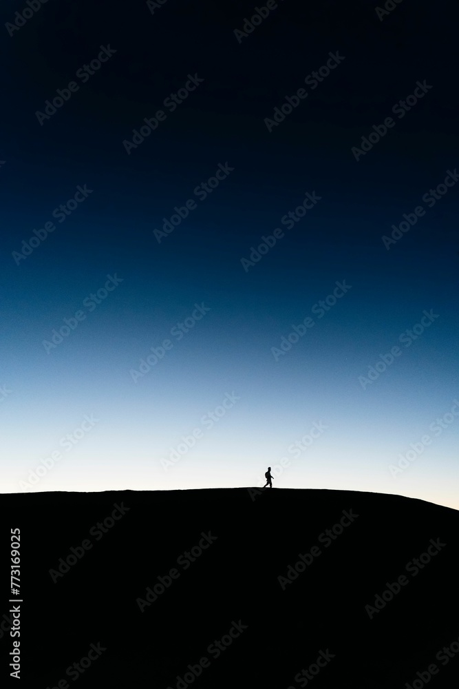 Vertical wallpaper of the silhouette of a hiker on the hillside in Rongshui County, Guangxi, China