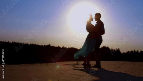 Silhouette of a man and a woman kissing on a white background