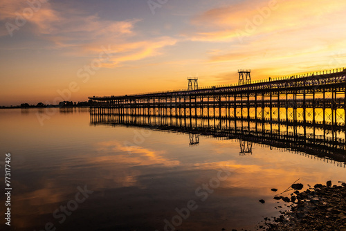 Captivating sunset scenery unfolds at The Rio Tinto Pier (Muelle de Rio Tinto) in Huelva, Andalusia, Spain