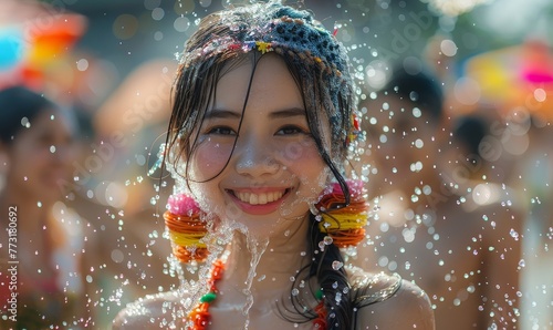 Young happy beauty Asian woman with friends wearing Thai tradstional wear plashing water during Water Songkran festival ,Thailand traditional
