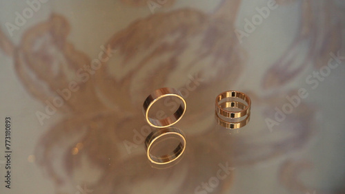 wedding rings on the background of a mirror, close-up