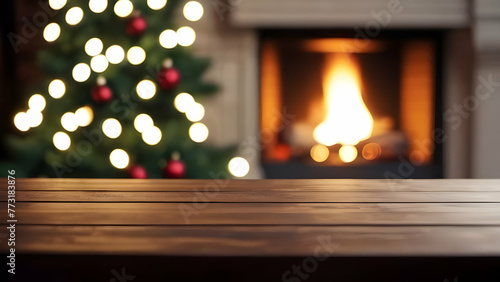 Empty wooden table with blurry christmas tree and fireplace background