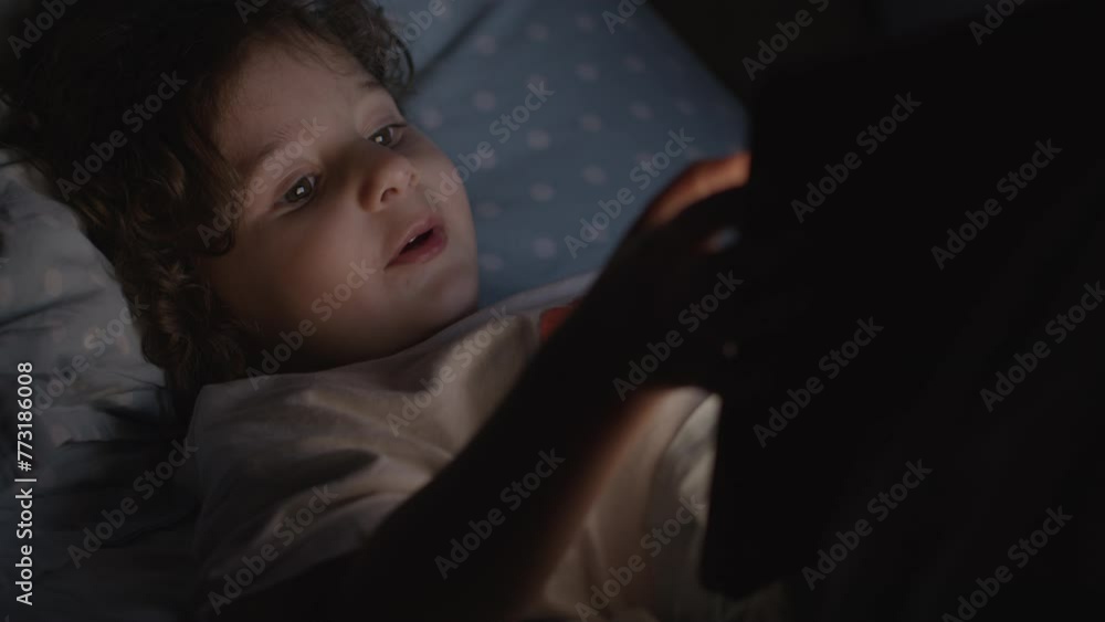 Boy enjoy digital tablet at night Boy enjoy digital tablet at night