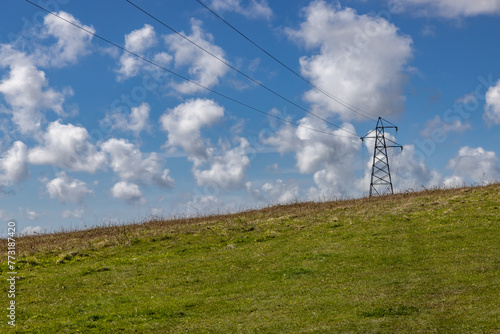 A rural South Downs landscape with an electricity pylon on a hillside © lemanieh