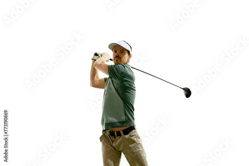 Athlete in golf attire doing perfect swing in motion and looking at distance against white studio background. Concept of professional sport, luxury games, active lifestyle, action. Ad