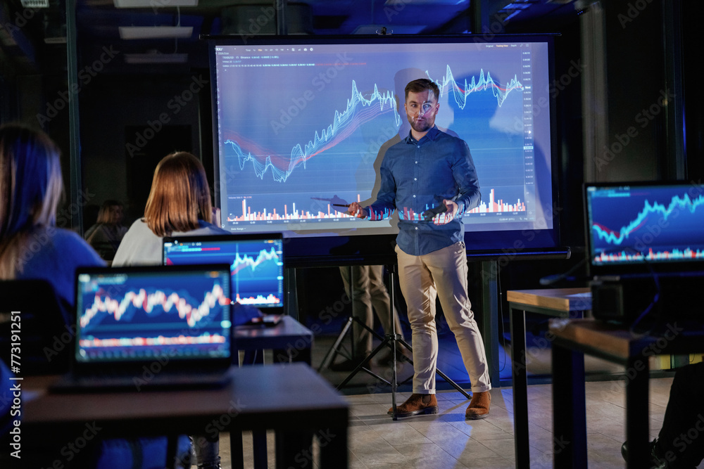 Fototapeta premium Graph is going up. Male business trainer is against projector with data, teaching people