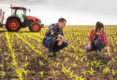 Young farmers examing planted corn