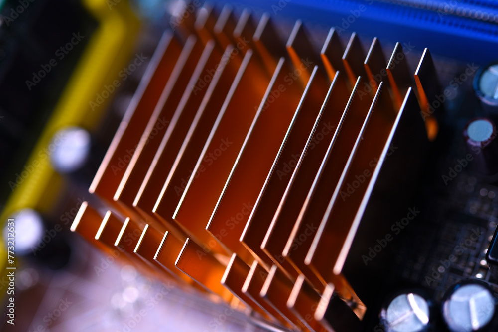 A copper radiator for cooling the chip on the computer board. Radio components.The computer's motherboard.