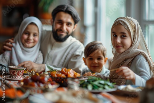 Happy Muslim family meeting around a table for breakfast or lunch